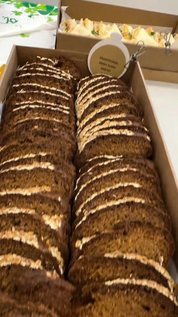 Slices of buttered Irish brown bread lined up in a catering box